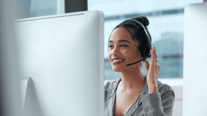 Smiling woman in call centre headset