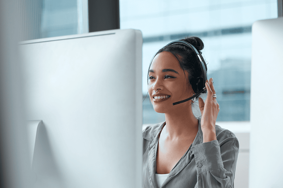 Smiling woman in call centre headset