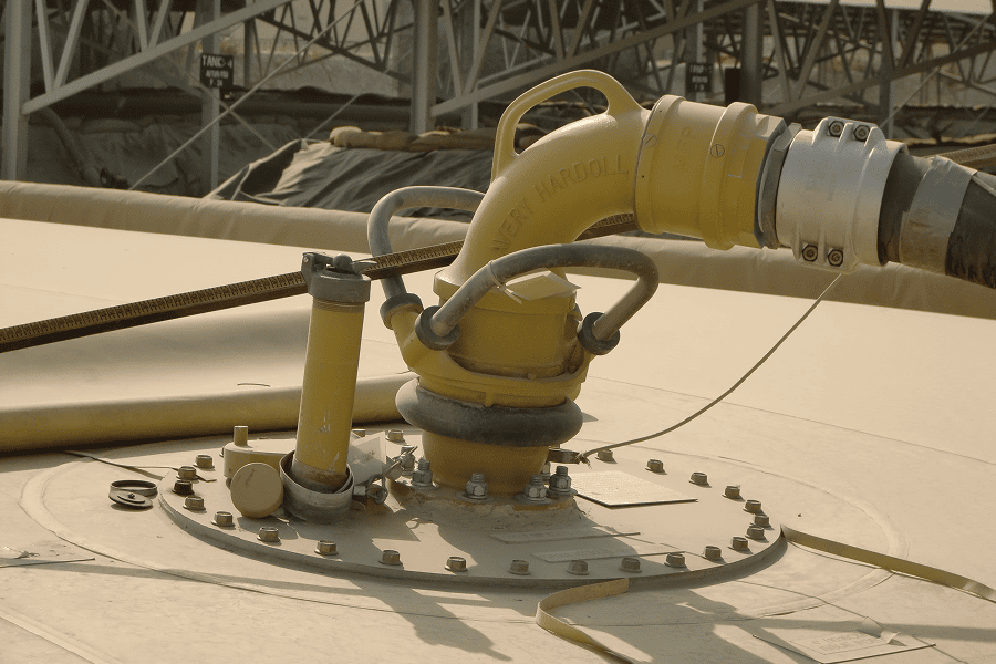 A fuel tank being refueled via an industrial pipeline