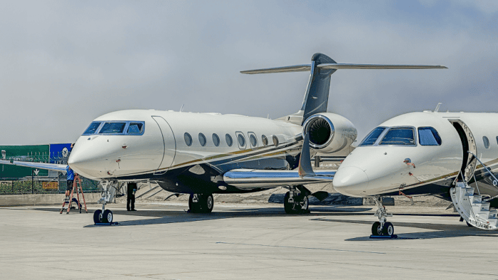 A premium government business jet parked on an airfield tarmac