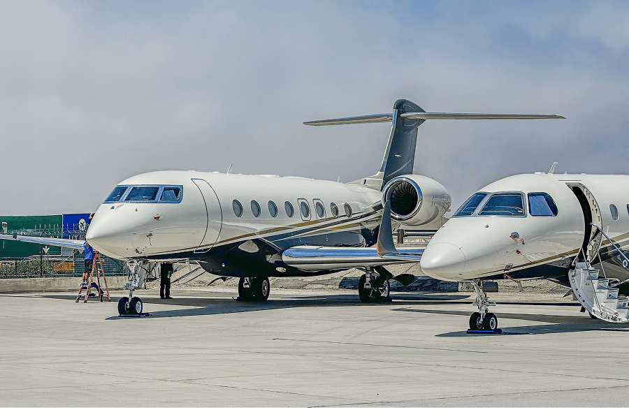 A premium government business jet parked on an airfield tarmac