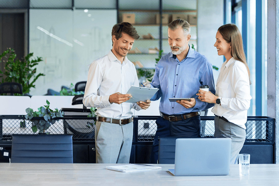 Three colleagues collaborating in an office.