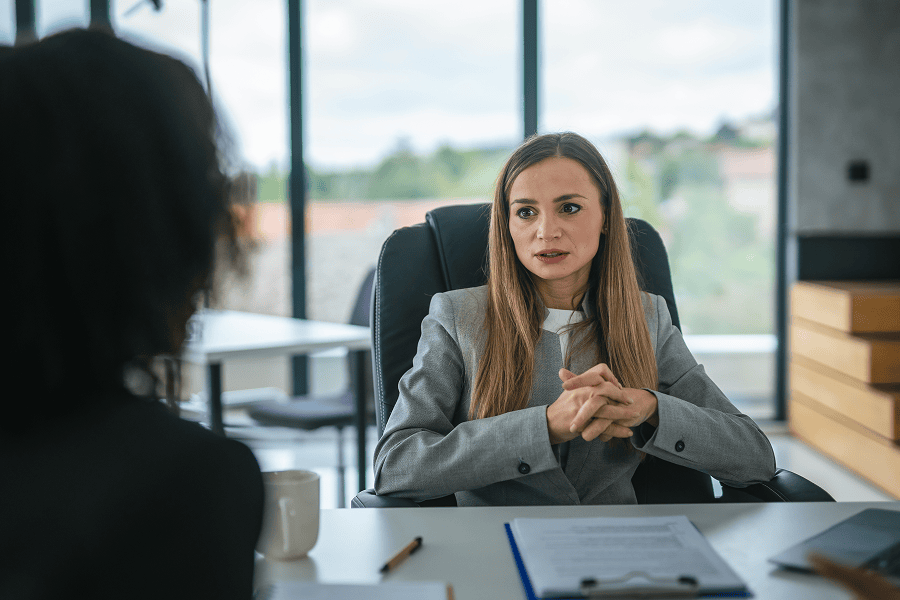 A human resource professional collaborating on recruitment strategies with a colleague in a corporate office setting.