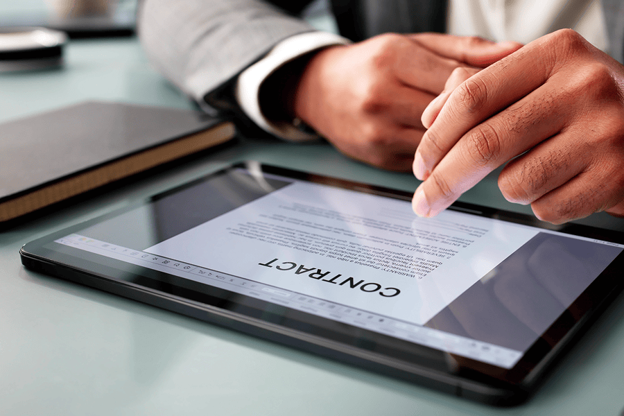 Man examining contract on a tablet.