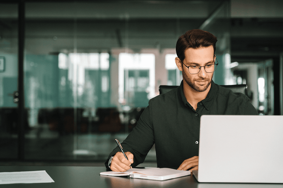 Man working on laptop in office.