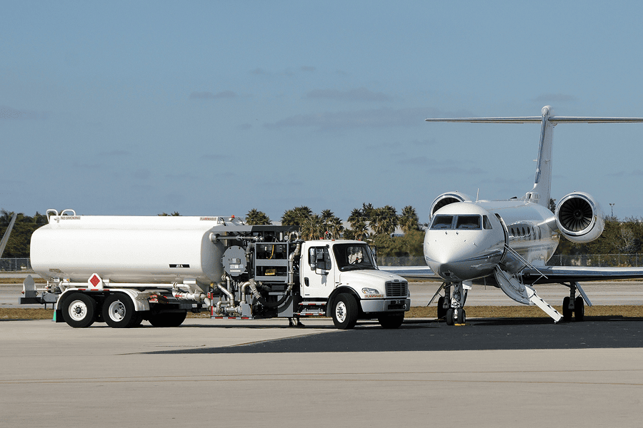 Fuel truck servicing a commercial aircraft on the airport apron.