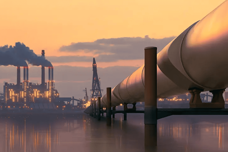 Pipeline beside factories at sunset.