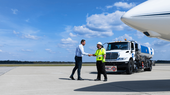 Pilot and crew member shaking hands.