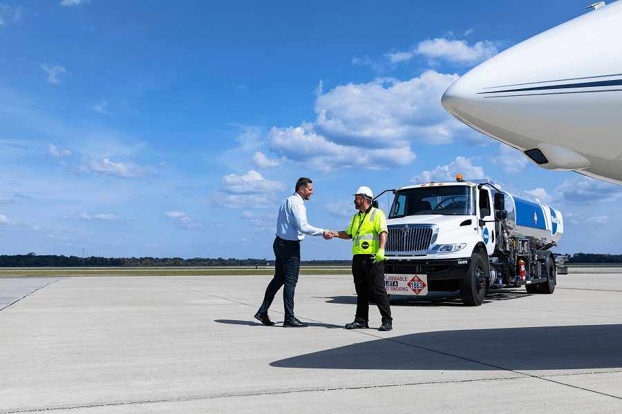Pilot and crew member shaking hands.