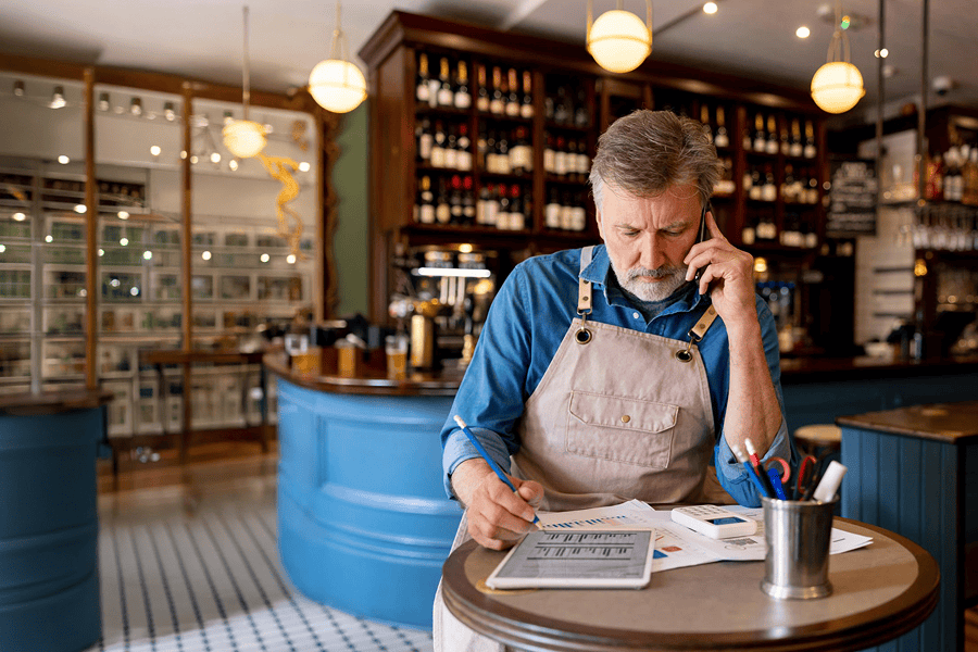 Man analysing charts while on phone.