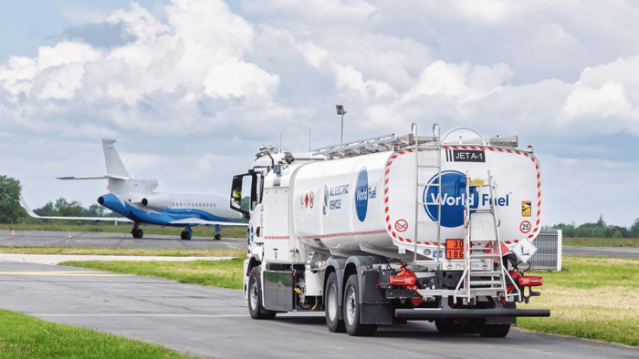 World Fuel truck driving toward airplane