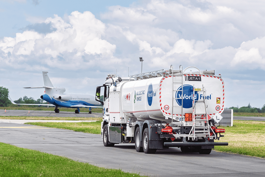 World Fuel truck driving toward airplane