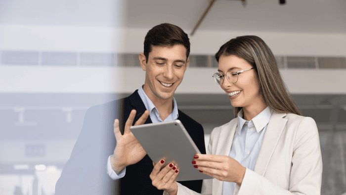 A professional sales manager explaining logistics metrics and performance charts using a digital tablet