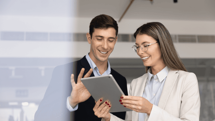 A professional sales manager explaining logistics metrics and performance charts using a digital tablet