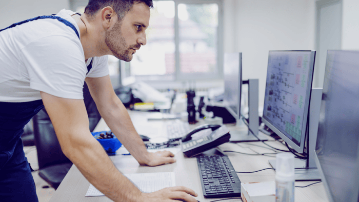 Engineer focused on computer screen.