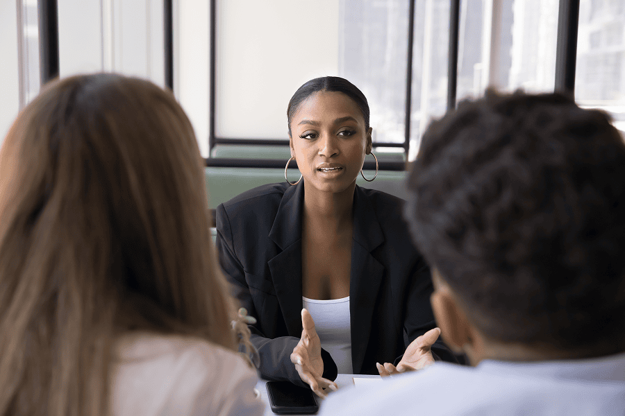 Woman discussing ideas with colleagues.