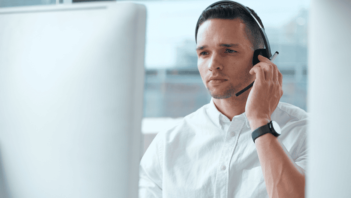 A professional young male agent wearing a communication headset