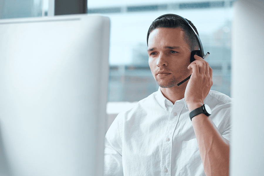 A professional young male agent wearing a communication headset