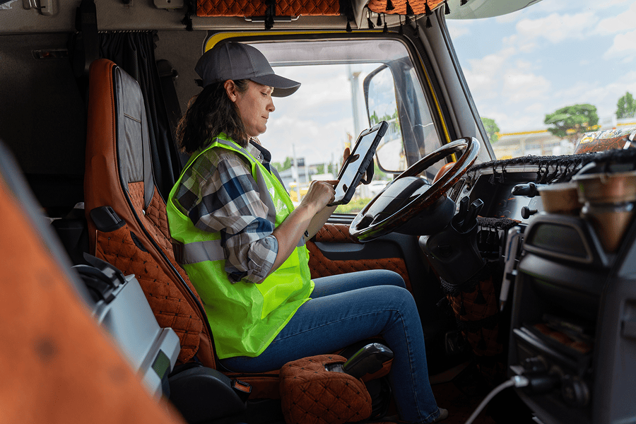 Woman looking at tablet inside truck