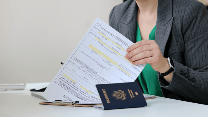 Person reviewing visa application documents.