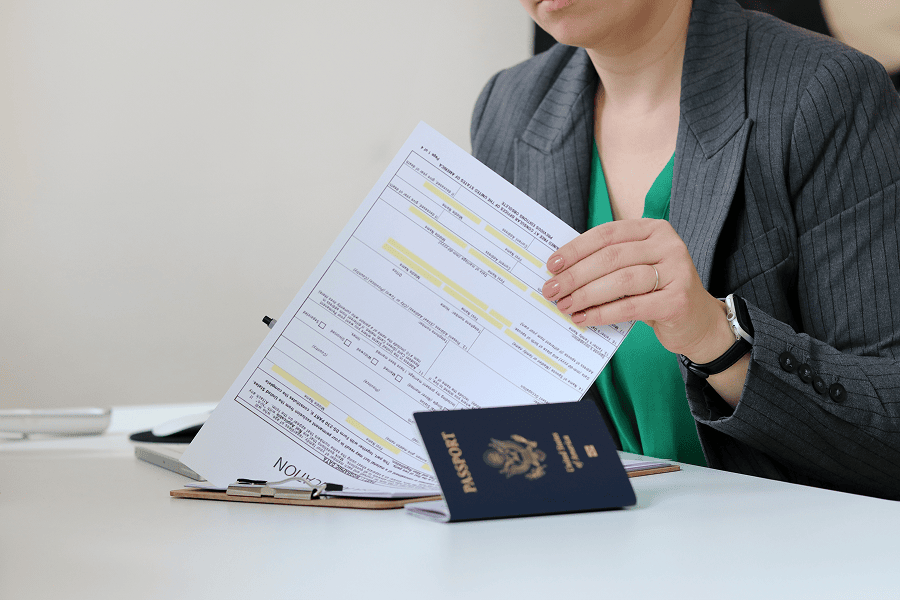 Person reviewing visa application documents.