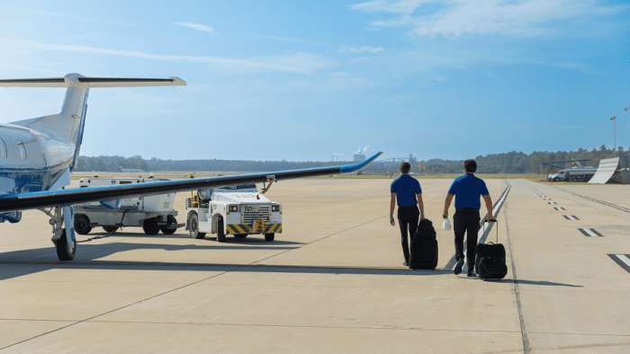 Two men walking with luggage