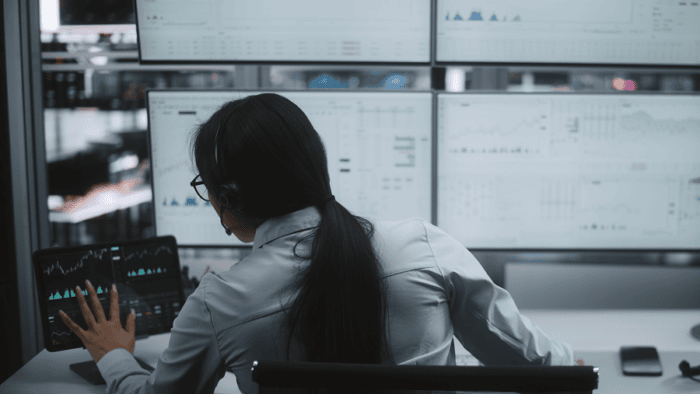 A female wearing a headset while analyzing real-time fleet data